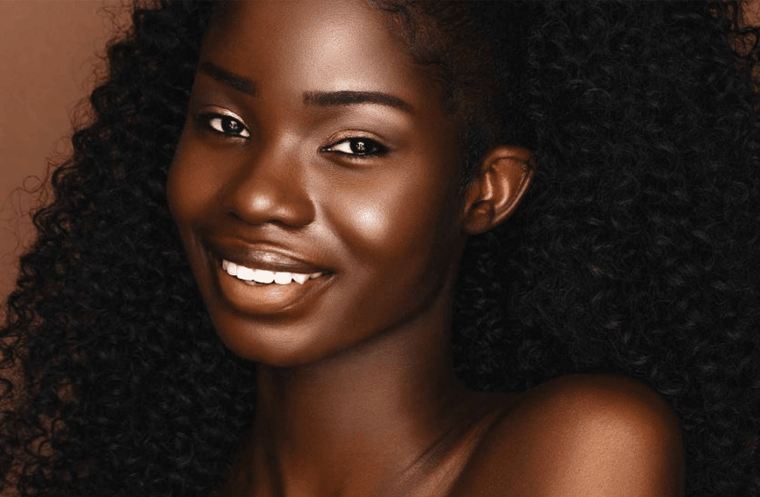 Portrait of a beautiful black woman smiling, looking at camera